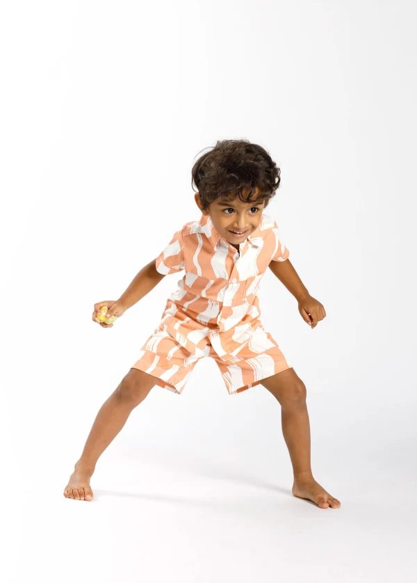 Child mid-dance in kidswear shoot