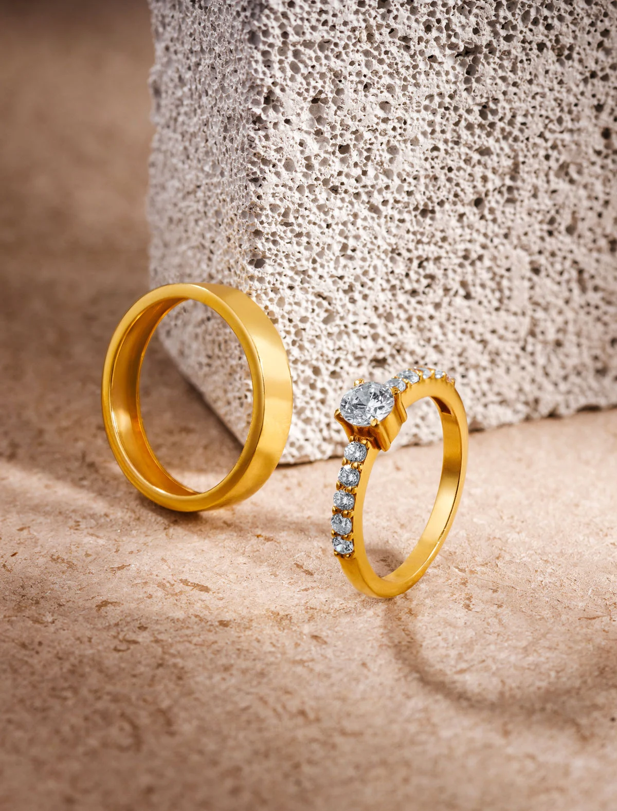 Gold rings on textured stone